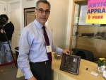 Michael Kasparian, CEO of the Falmouth Chamber of Commerce is also a Certified Antiques Appraiser.  Seen here checking out an item at the Falmouth Preservation Alliance Expo on 05-20-17.