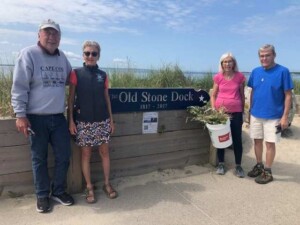 2023 06-10 OSDA Treasurer Bob Lehtinen, Beach Committee Member Geralyn Schad, OSDA Member Polly Thayer and OSDA President Jay Thayer standing by the sign the OSDA previous made and donated in 2017 commemorating the 200th anniversary of the Old Stone Dock.